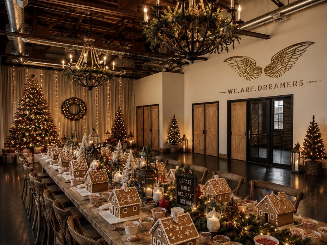 A long table set for a gingerbread house workshop, Christmas trees and lanterns filling the room