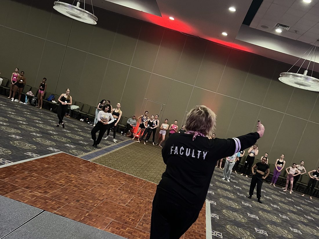 Teaching a master class to a room of dancers at a convention